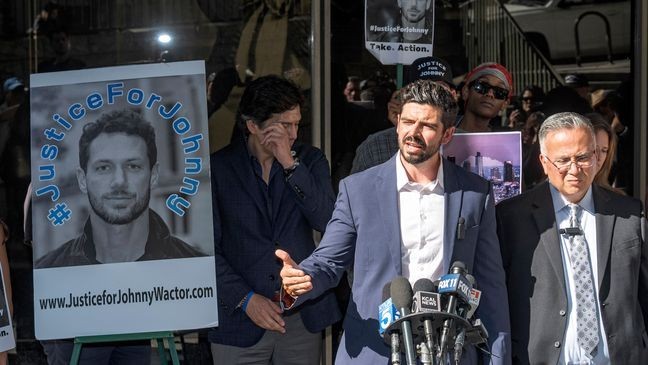 Actor Micah Parker "Vampire Diaries," organizer of Justice for Johnny Wactor, at the podium, speaks at a news conference outside the Clara Shortridge Foltz Criminal Justice Center in Los Angeles, Monday, Aug. 19, 2024. Standing, Los Angeles City Council member Kevin de Leon, rear left, and detective Moses Castillo, front right. (AP Photo/Damian Dovarganes)