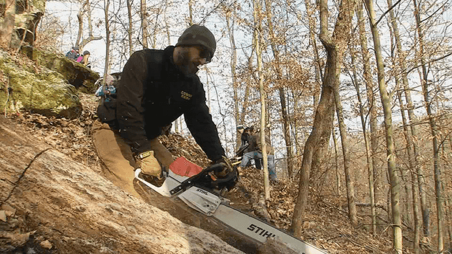 Self proclaimed CFO (Chief Fun Officer) cuts a tree from the trail. (WCHS/WVAH)